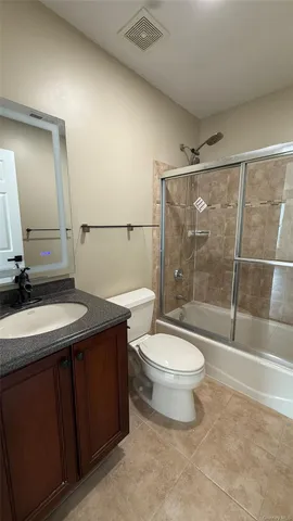a bathroom with a sink a toilet and a shower