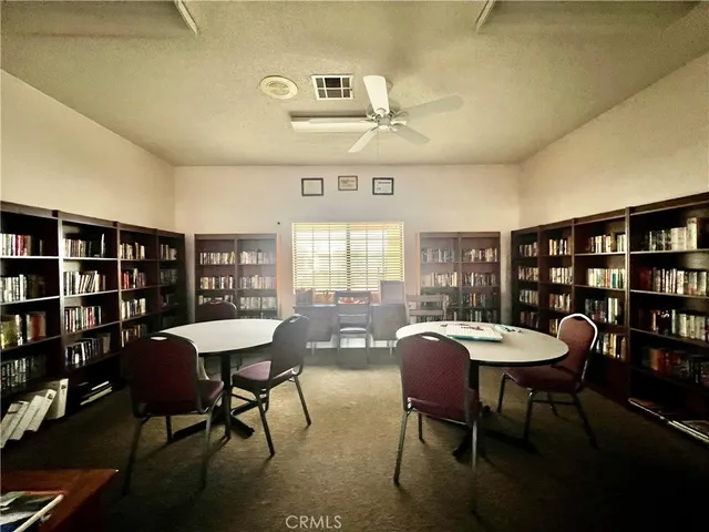 a view of a dining room with furniture and a book shelf