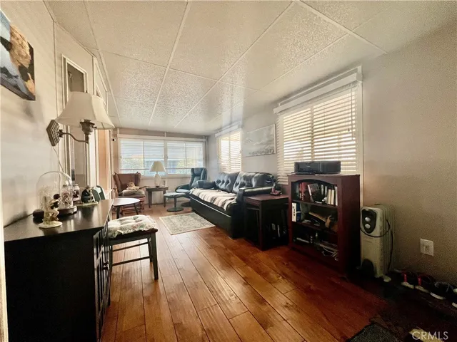 a living room with furniture window and wooden floor