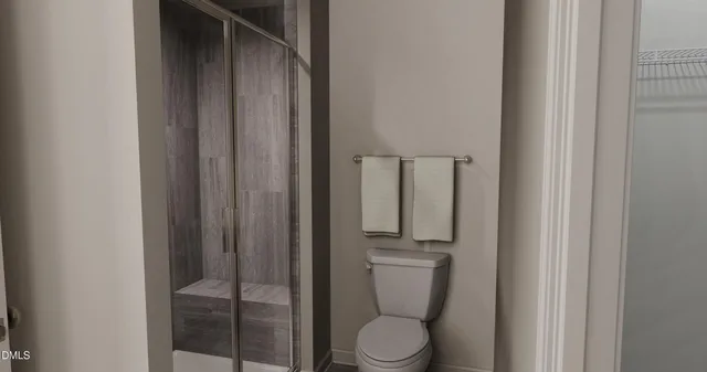 a white toilet sitting next to a bathroom