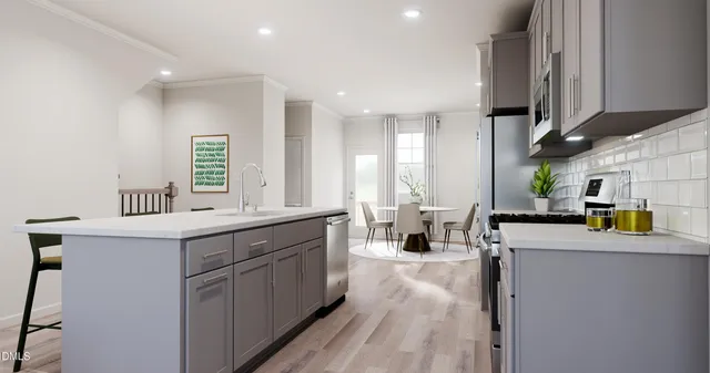 a kitchen with a sink a counter space appliances and cabinets