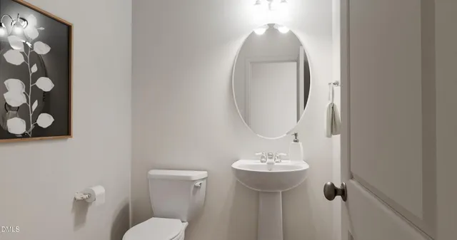 a bathroom with a sink toilet and mirror