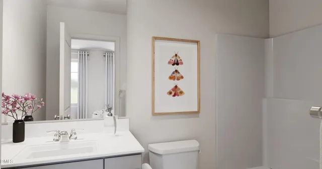 a bathroom with a sink a toilet and a mirror