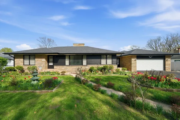 a front view of house with yard and green space