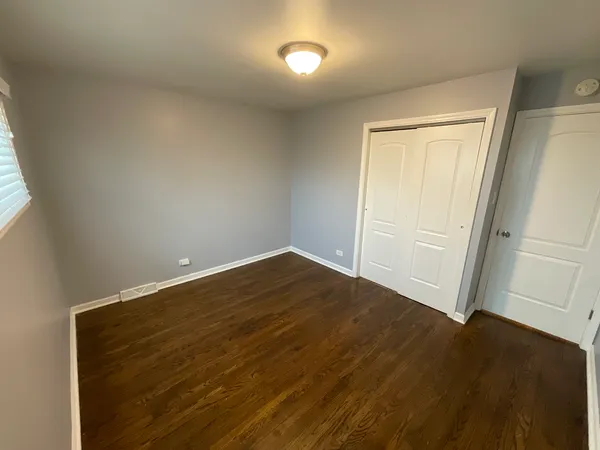 an empty room with wooden floor