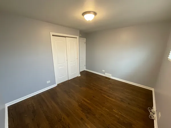an empty room with wooden floor