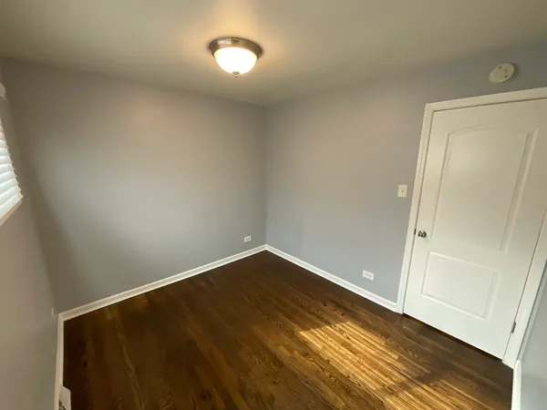 an empty room with wooden floor