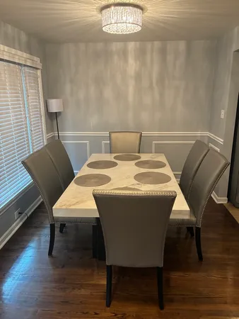 a view of a dining room with furniture and wooden floor