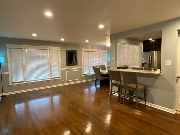 a view of a dining room with furniture and wooden floor