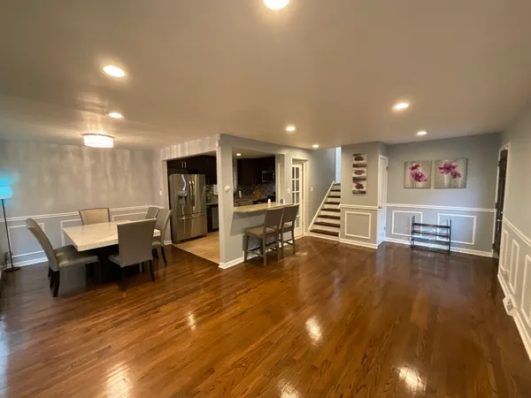 a view of a room with wooden floor and furniture