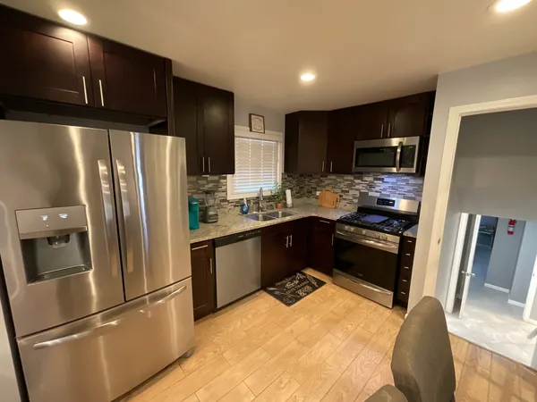 a kitchen with stainless steel appliances a refrigerator and a stove top oven