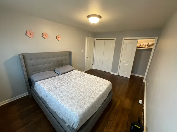 a bedroom with a bed and a dresser