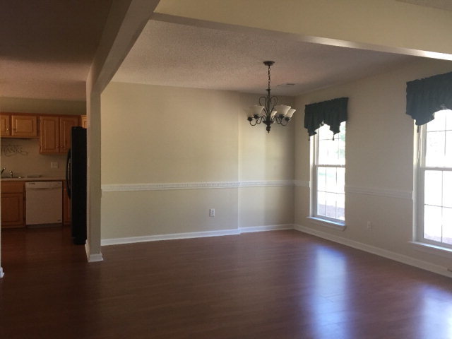 3416 Lower Hartley Bridge Road Byron, GA 31008 - Photo 2 of 28 an empty room with wooden floor chandelier and windows