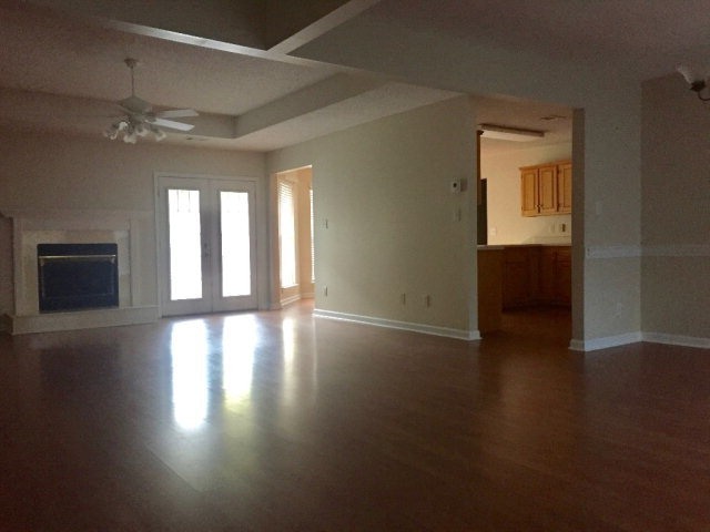 3416 Lower Hartley Bridge Road Byron, GA 31008 - Photo 3 of 28 a view of an empty room with wooden floor and a window
