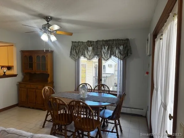 a view of a dining room with furniture and window