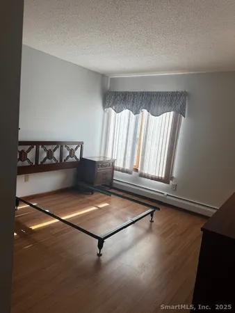 a living room with hard wood floors and a window