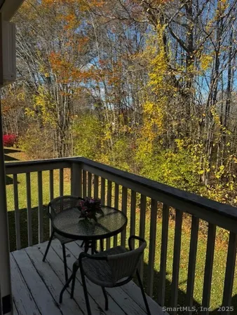 a view of a wooden bench and table in the balcony