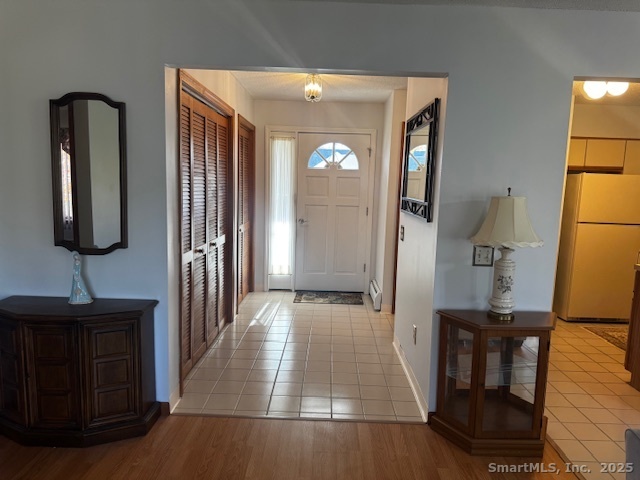 24 Millbrook Court Newington, CT 06111 - Photo 8 of 12 a view of a hallway with wooden floor and cabinet