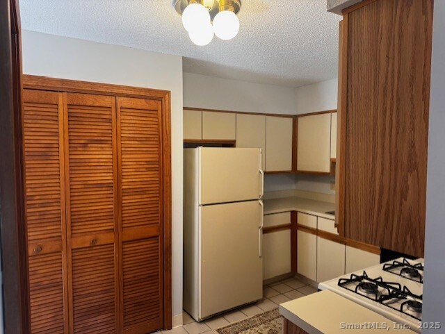 24 Millbrook Court Newington, CT 06111 - Photo 10 of 12 a refrigerator freezer sitting inside of a kitchen