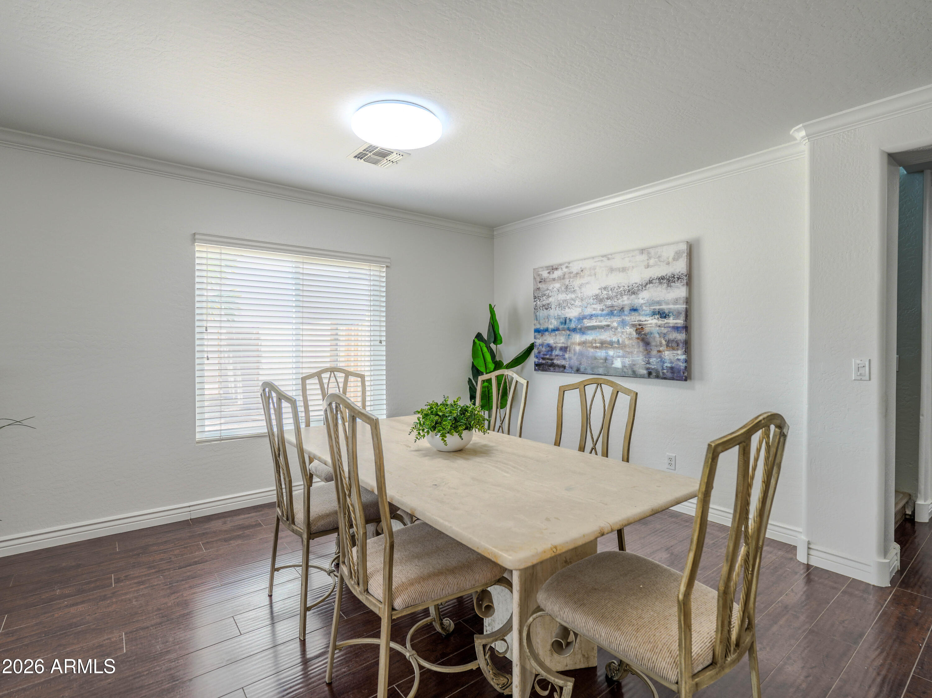 3378 East Silverbell Road San Tan Valley, AZ 85143 - Photo 12 of 61 a view of a dining room with furniture window and wooden floor