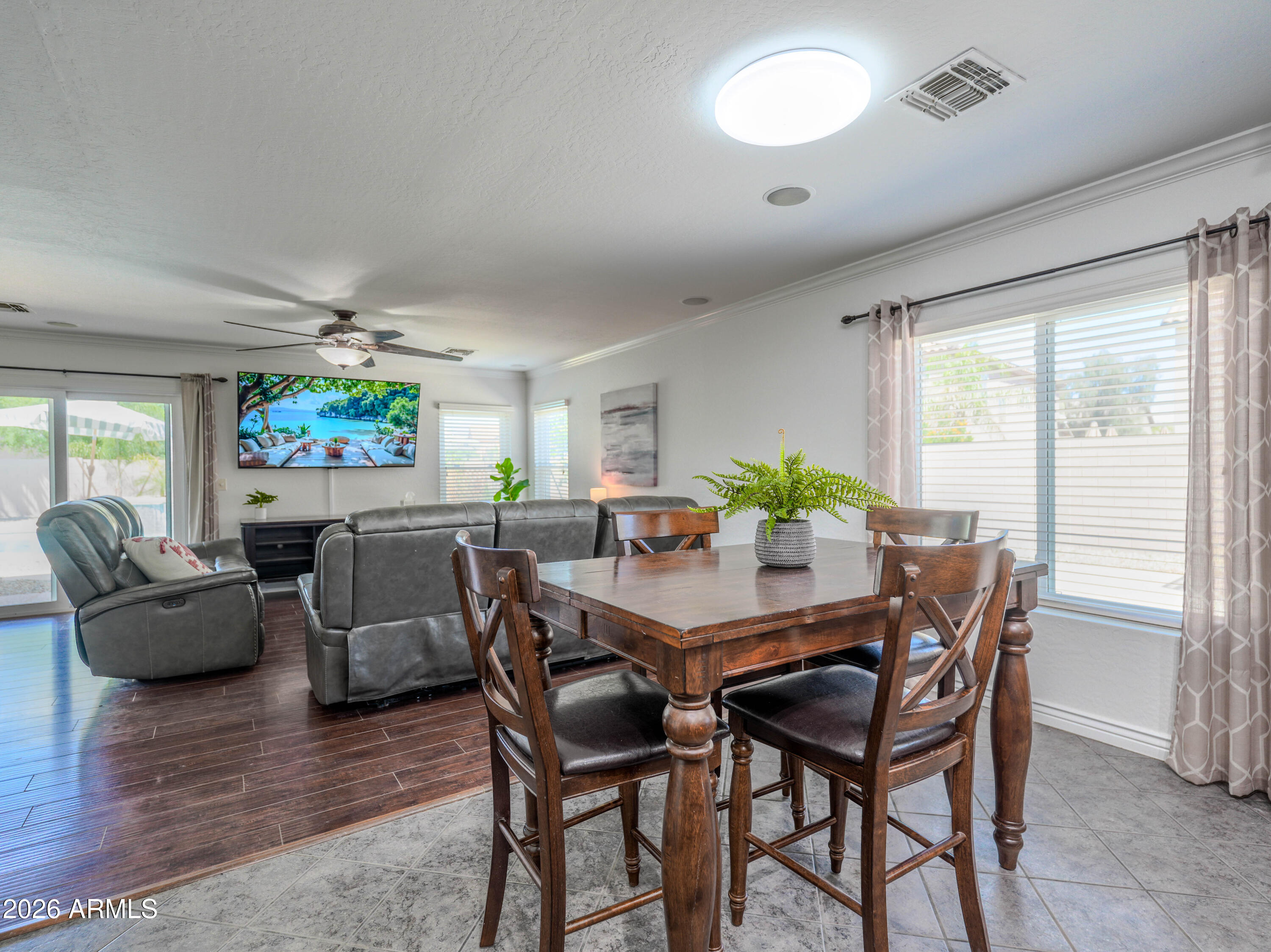 3378 East Silverbell Road San Tan Valley, AZ 85143 - Photo 17 of 61 a view of a dining room with furniture and a potted plant