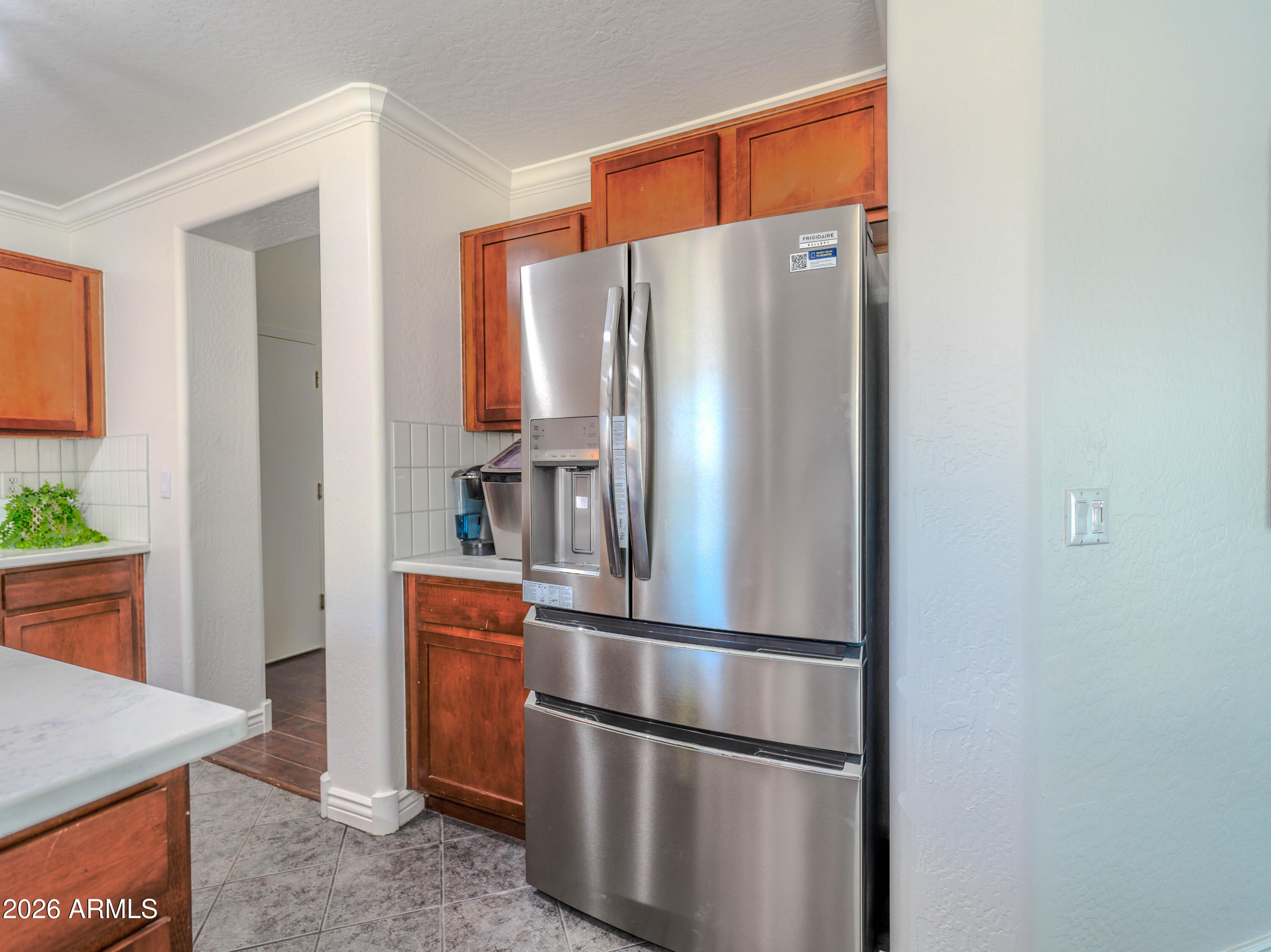3378 East Silverbell Road San Tan Valley, AZ 85143 - Photo 21 of 61 a metallic refrigerator freezer sitting in a kitchen