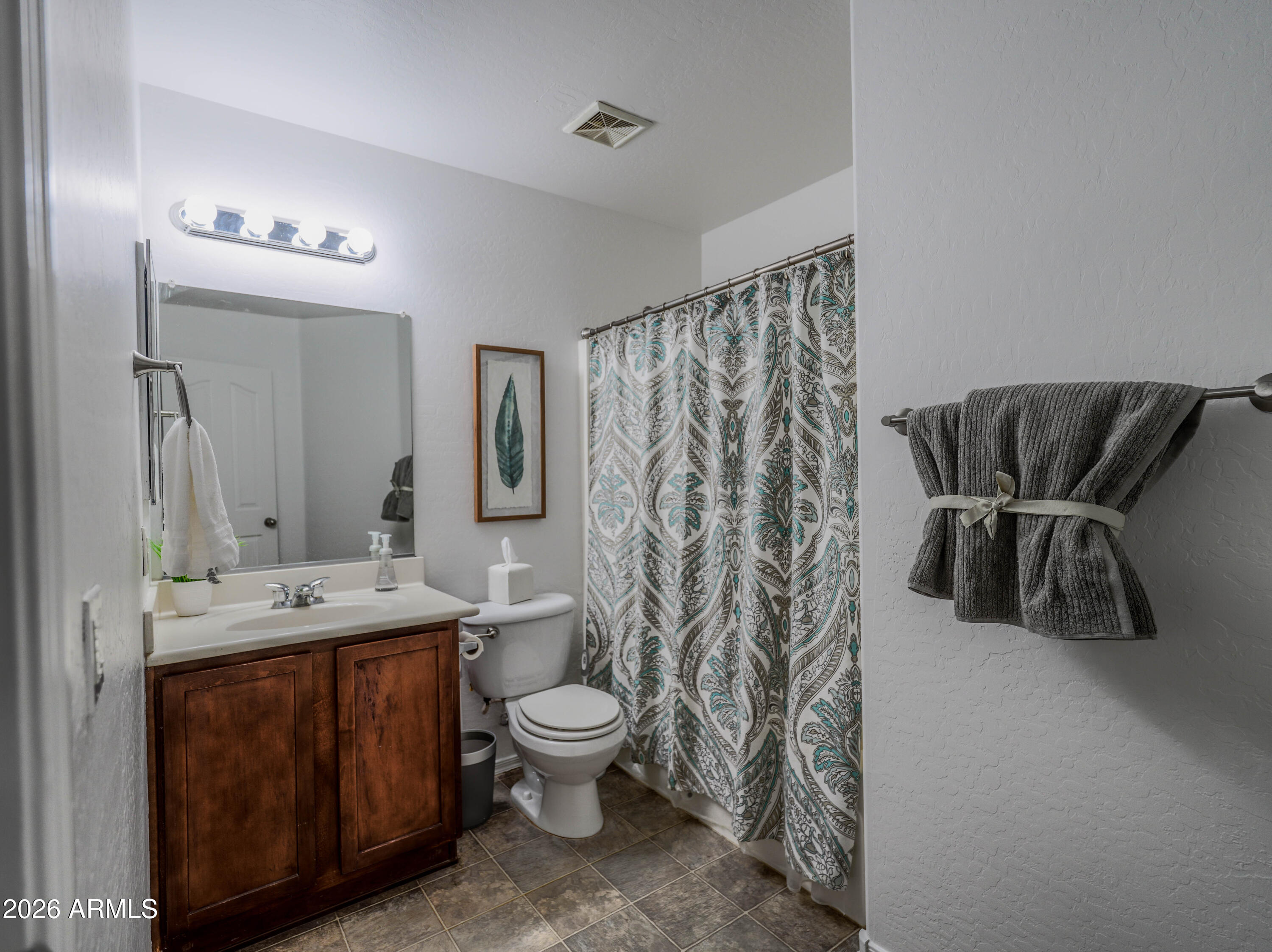 3378 East Silverbell Road San Tan Valley, AZ 85143 - Photo 24 of 61 a bathroom with a toilet sink and mirror