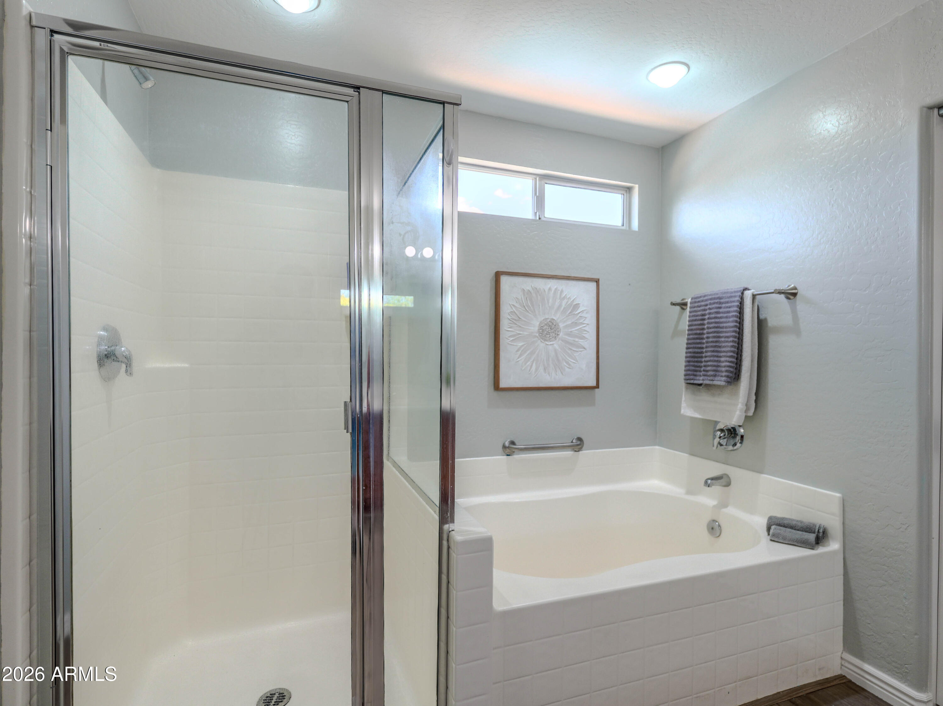 3378 East Silverbell Road San Tan Valley, AZ 85143 - Photo 30 of 61 a white bath tub sitting next to a white sink and mirror