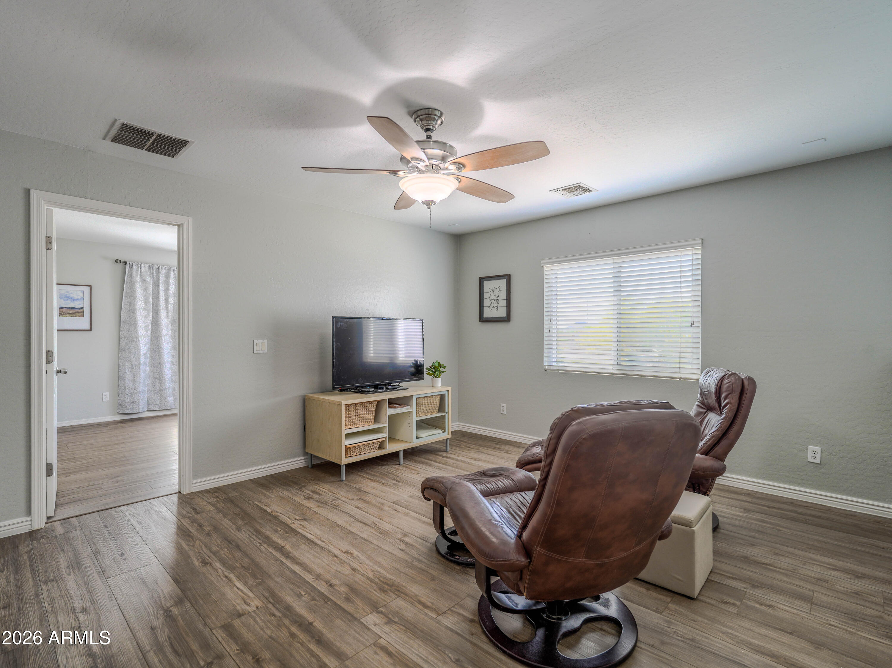 3378 East Silverbell Road San Tan Valley, AZ 85143 - Photo 32 of 61 a living room with furniture and a flat screen tv