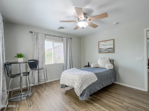 a spacious bedroom with a bed and a window