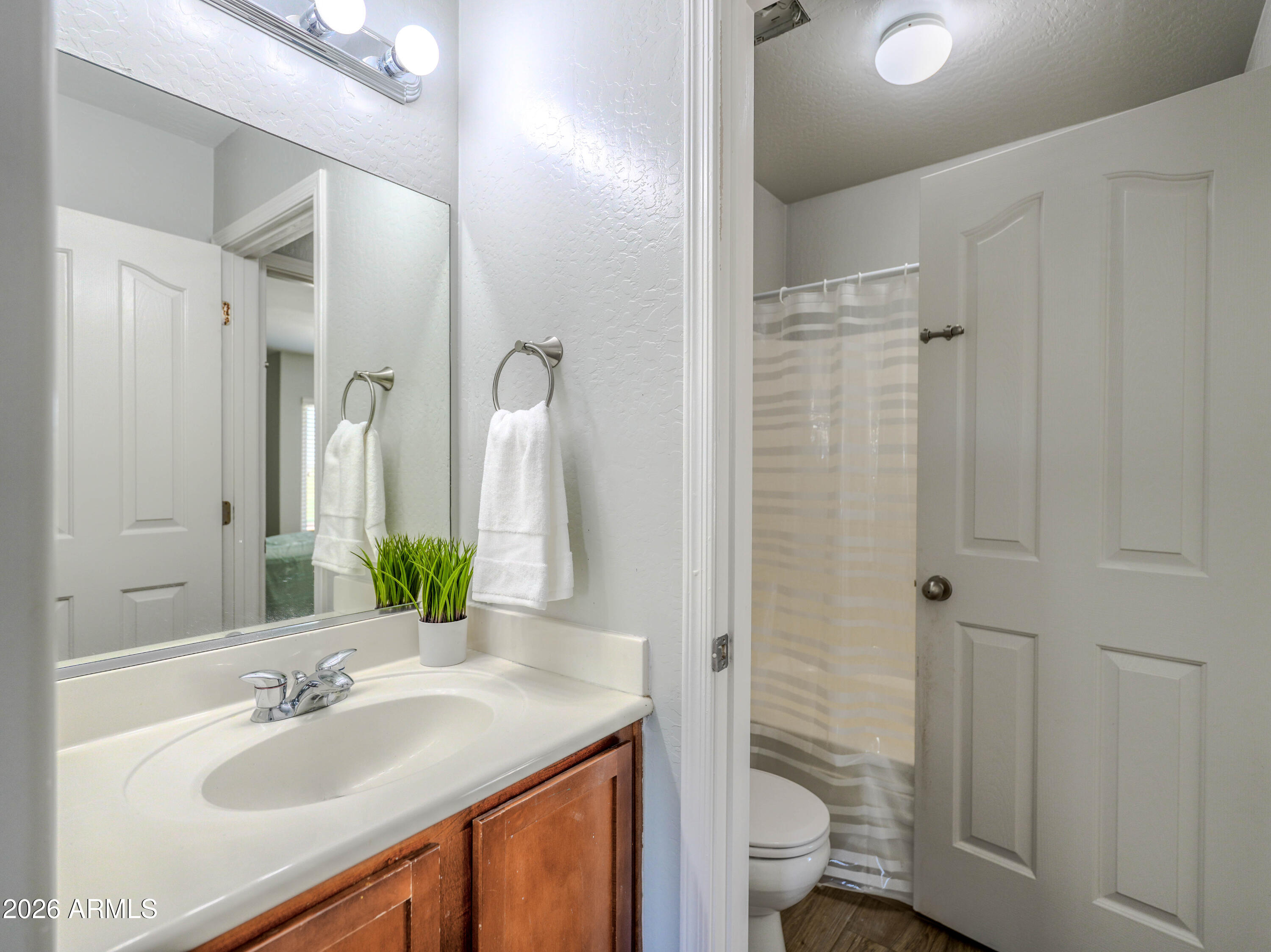 3378 East Silverbell Road San Tan Valley, AZ 85143 - Photo 35 of 61 a bathroom with a granite countertop sink toilet and shower
