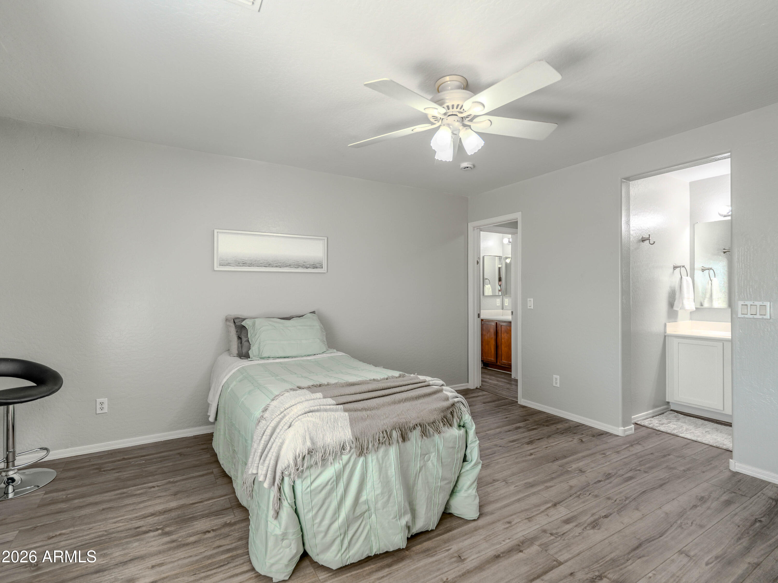 3378 East Silverbell Road San Tan Valley, AZ 85143 - Photo 37 of 61 a bedroom with a bed and wooden floor