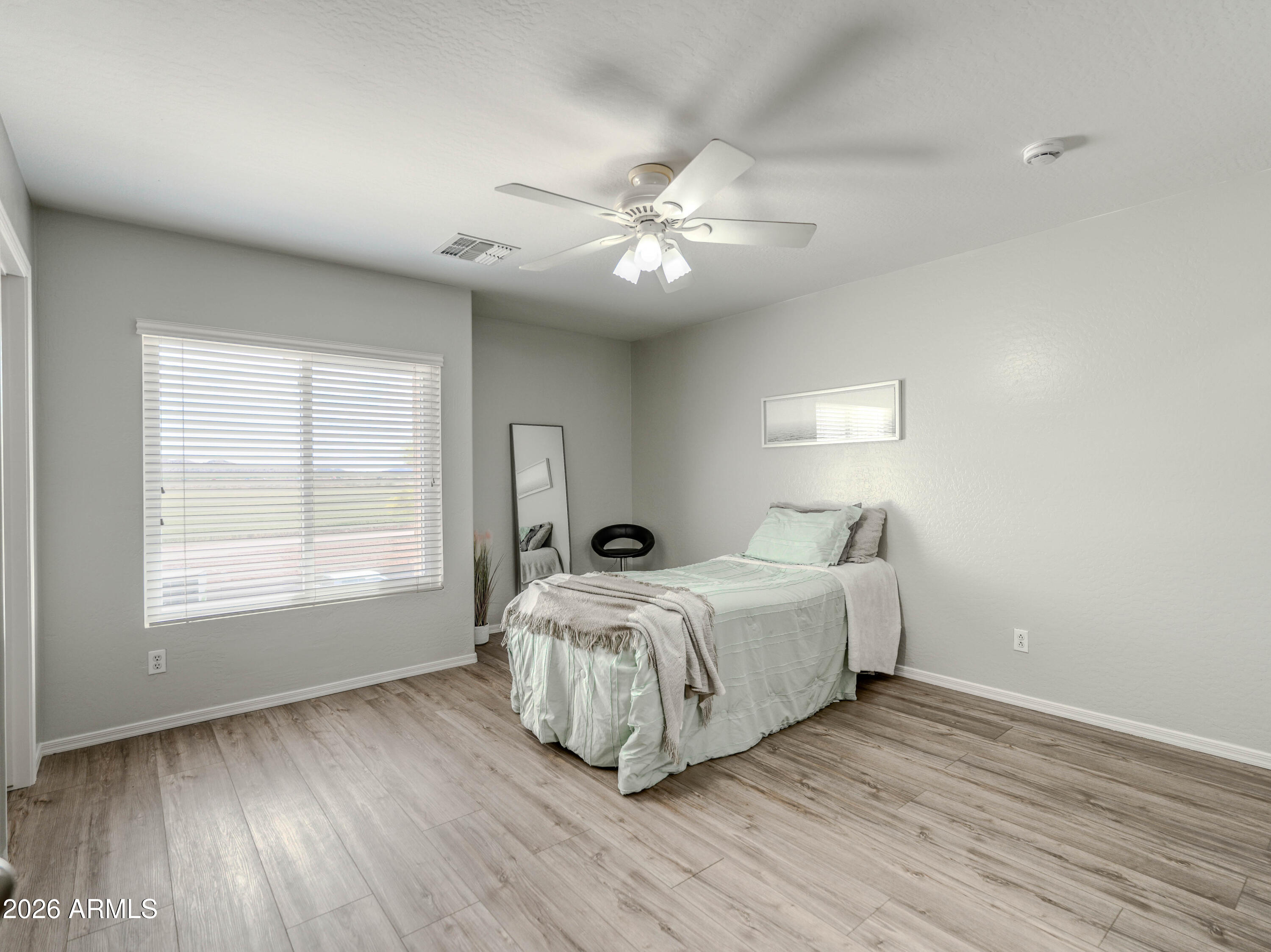 3378 East Silverbell Road San Tan Valley, AZ 85143 - Photo 38 of 61 a spacious bedroom with a bed and a window
