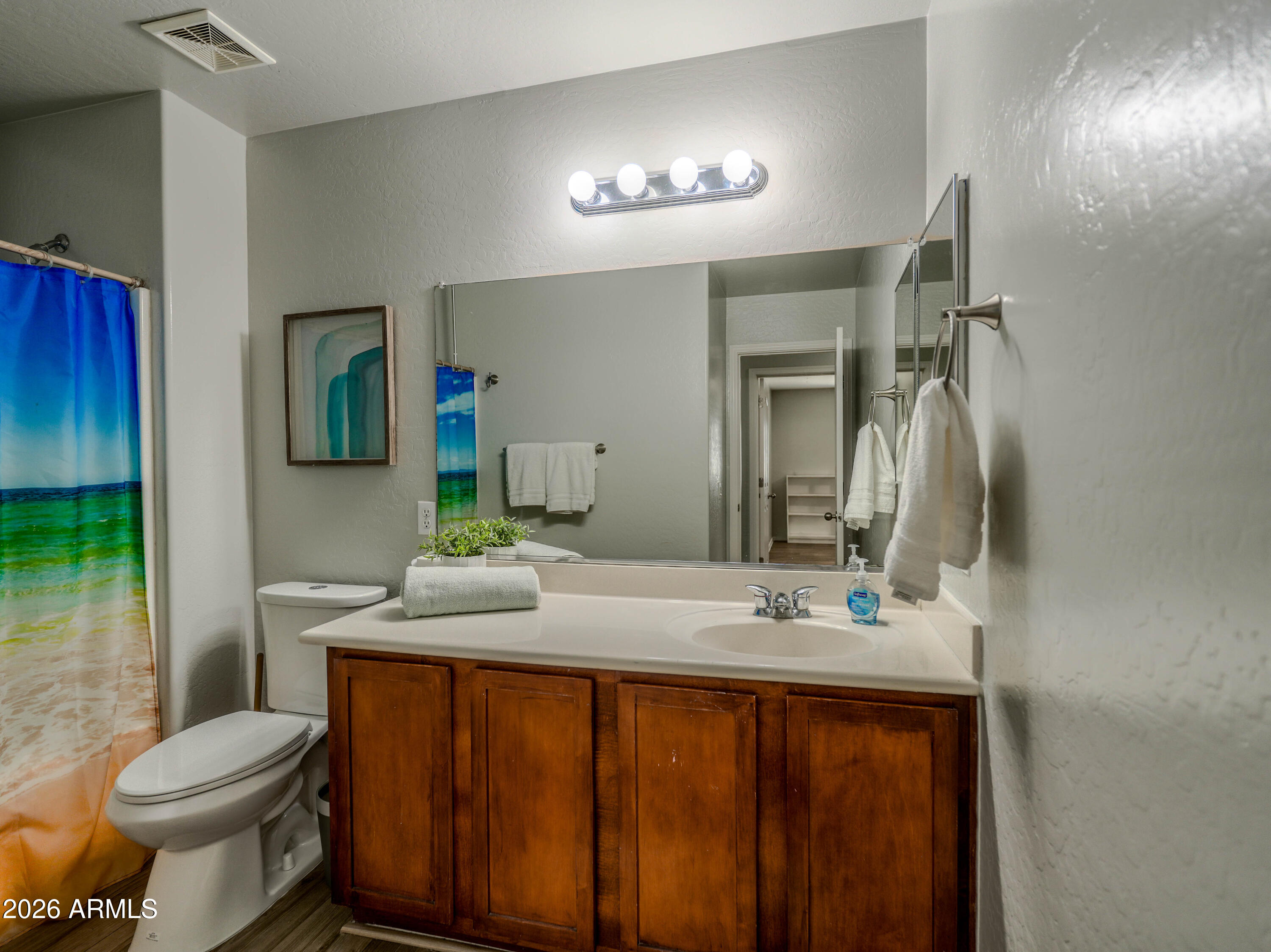 3378 East Silverbell Road San Tan Valley, AZ 85143 - Photo 46 of 61 a bathroom with a granite countertop sink toilet and mirror