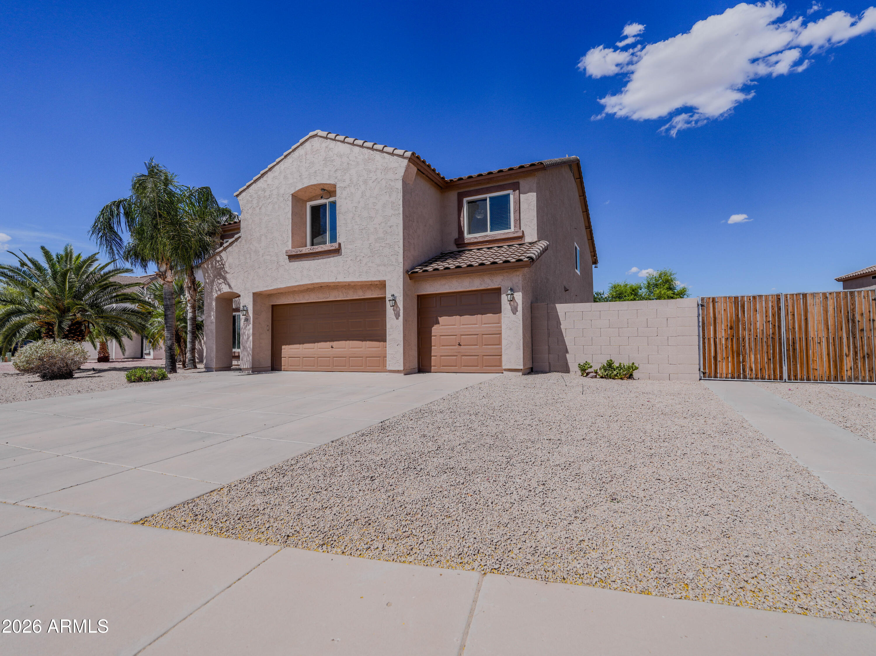 3378 East Silverbell Road San Tan Valley, AZ 85143 - Photo 59 of 61 a front view of a house with a yard and garage