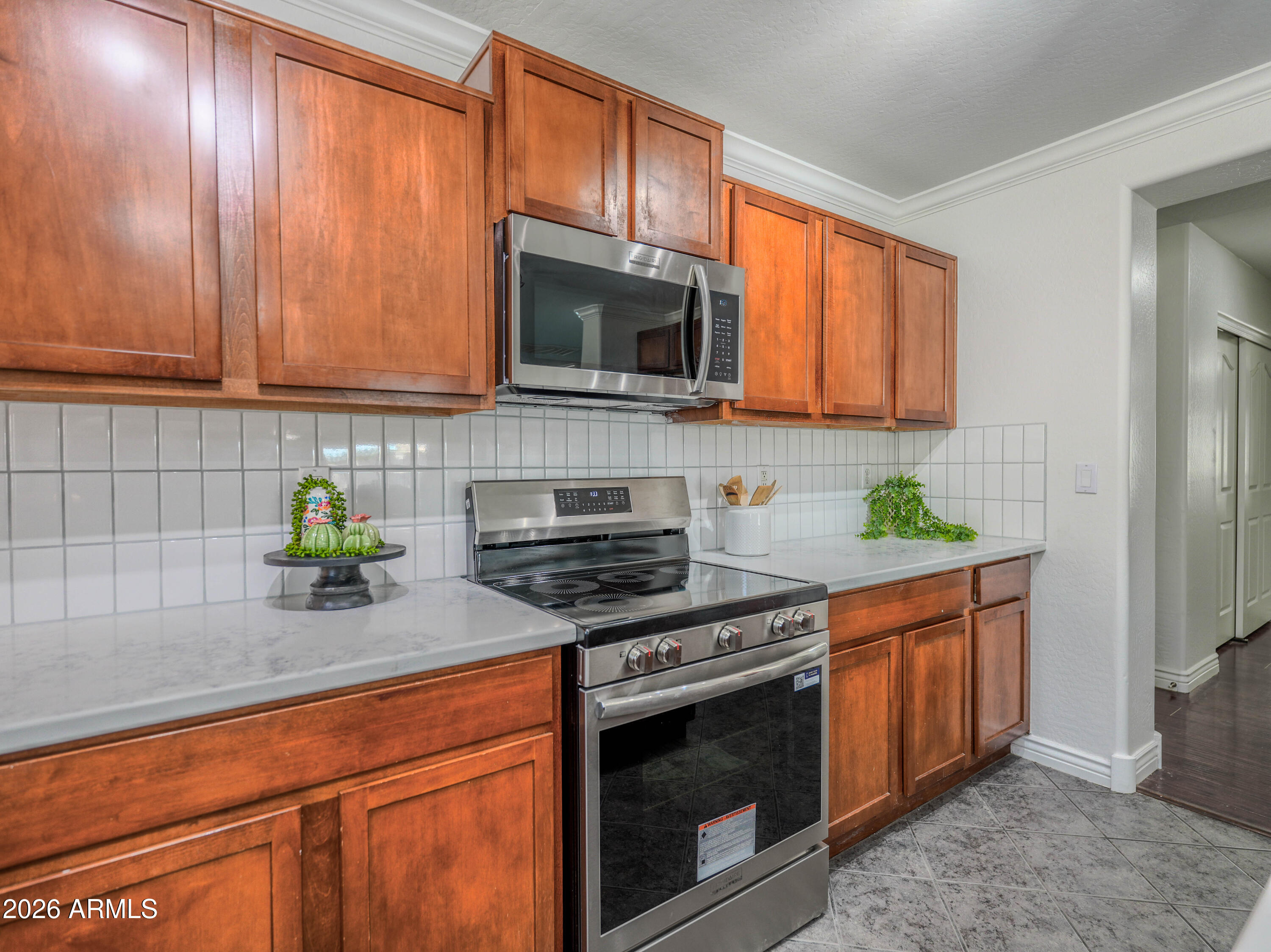 3378 East Silverbell Road San Tan Valley, AZ 85143 - Photo 7 of 61 a kitchen with stainless steel appliances granite countertop a stove a sink and a microwave
