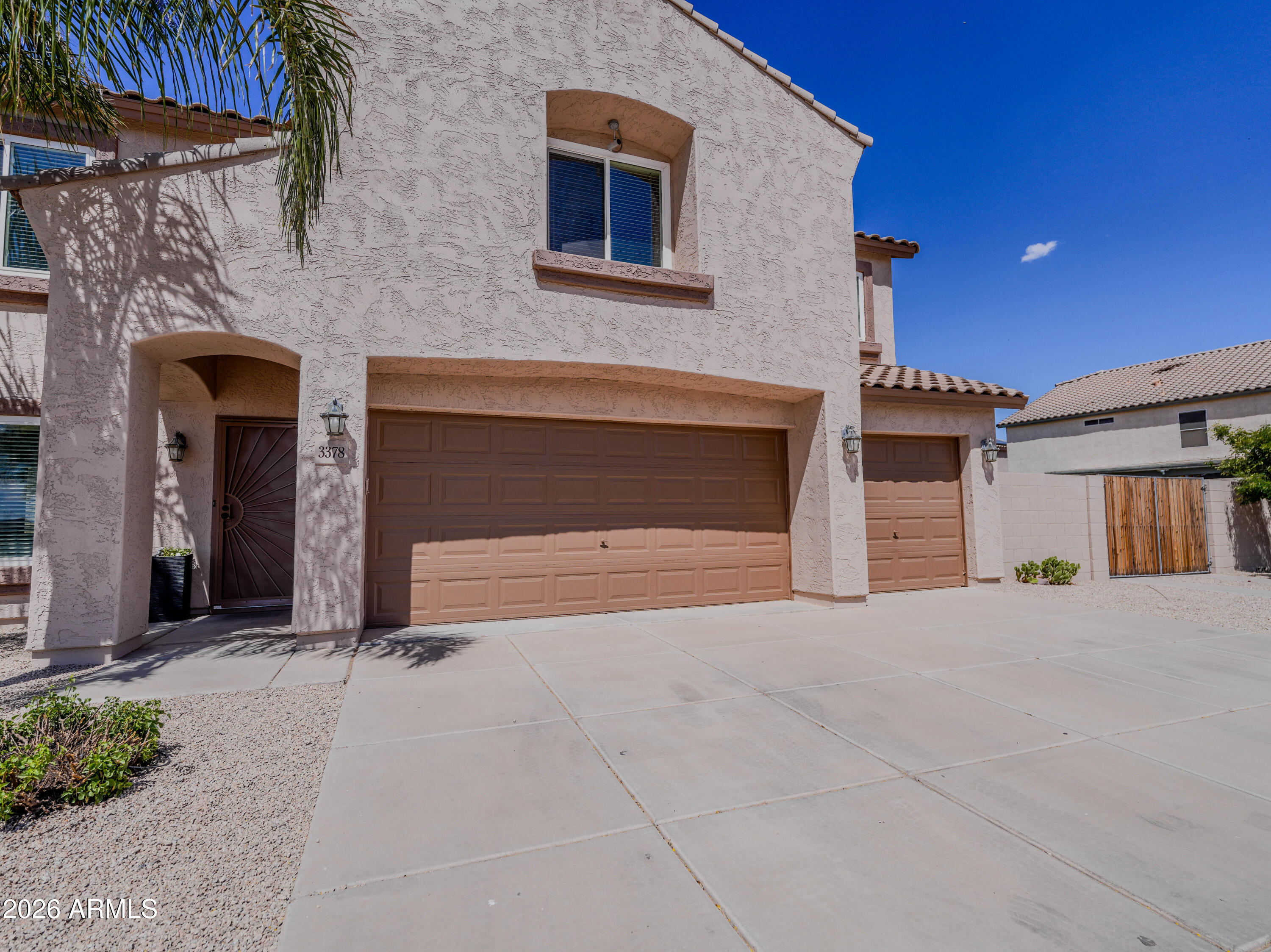 3378 East Silverbell Road San Tan Valley, AZ 85143 - Photo 10 of 61 a view of a house with a garage and fireplace