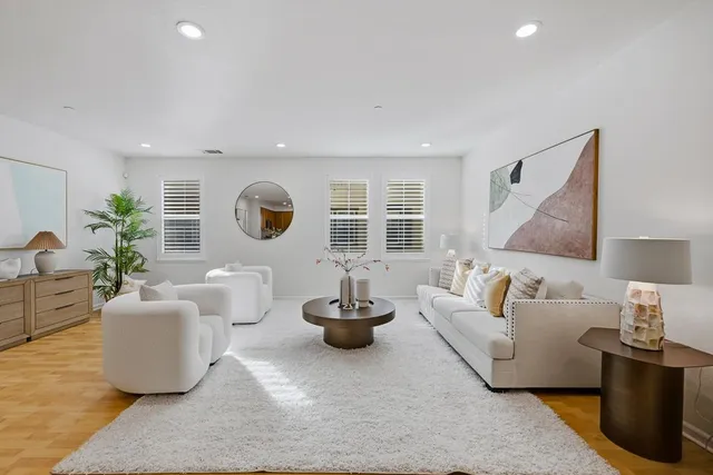 a living room with a table and a potted plant
