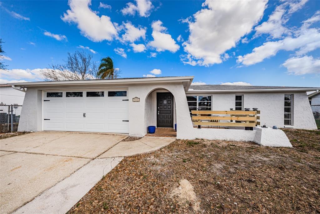 9426 Legend Lane Port Richey, FL 34668 - Photo 1 of 1 a front view of a house with a yard