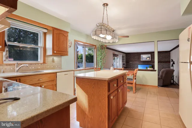 a kitchen with a sink a counter top space and stainless steel appliances