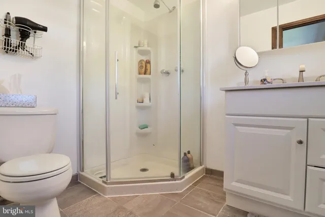 a bathroom with a toilet a sink and shower