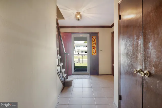 a view of a hallway with wooden shelves