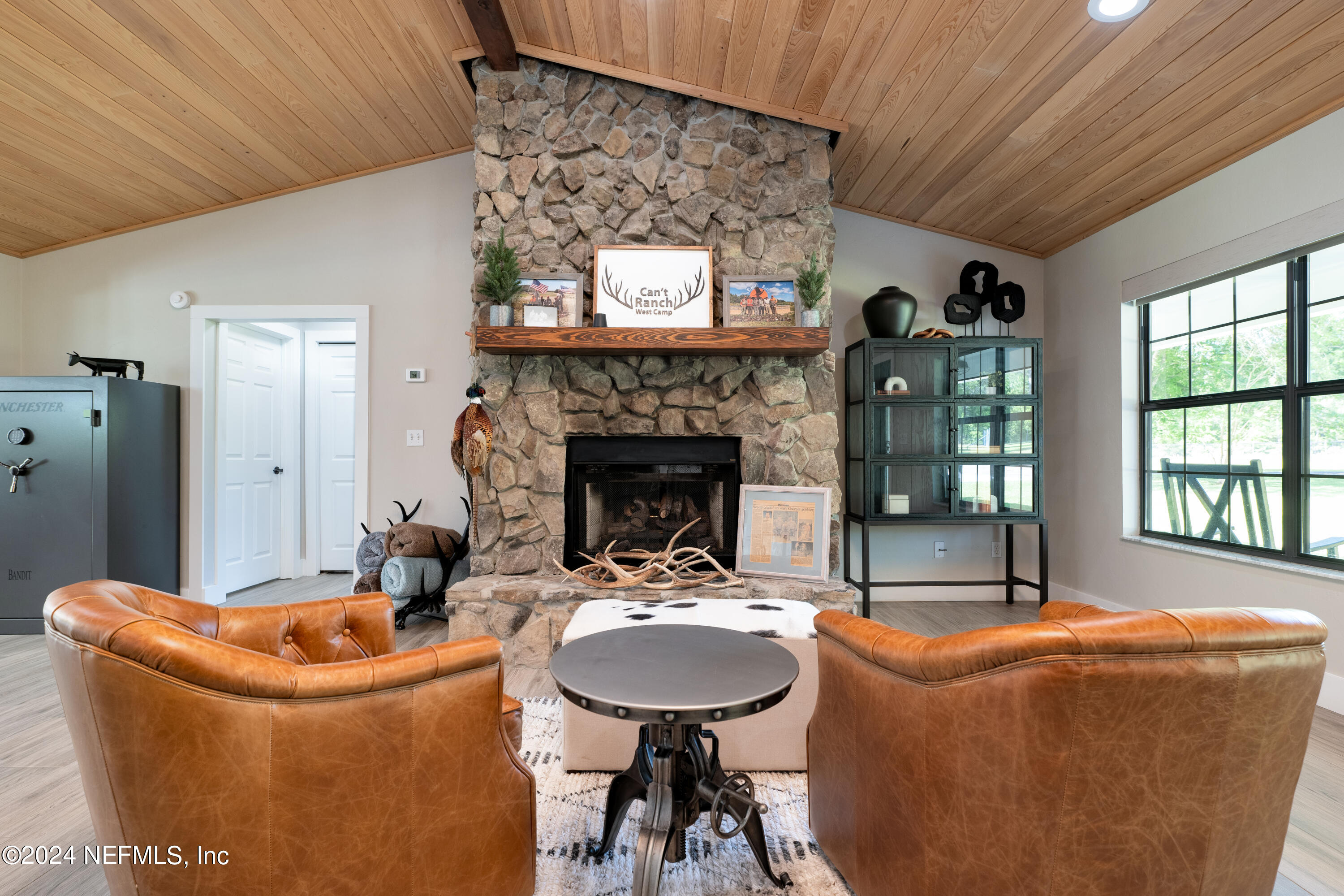 5800 Retreat Road Keystone Heights, FL 32656 - Photo 20 of 121 a living room with furniture a fireplace and a chandelier