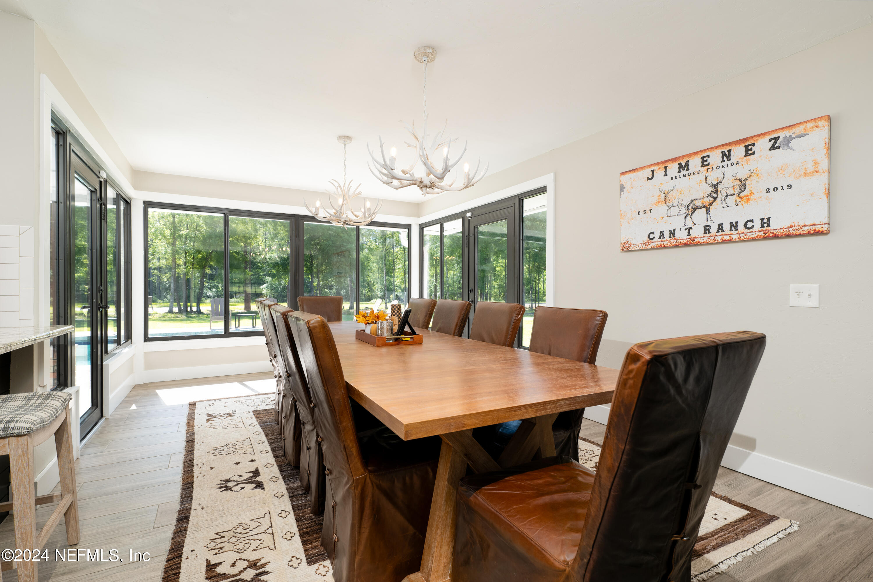 5800 Retreat Road Keystone Heights, FL 32656 - Photo 36 of 121 a view of a dining room with furniture wooden floor and a chandelier