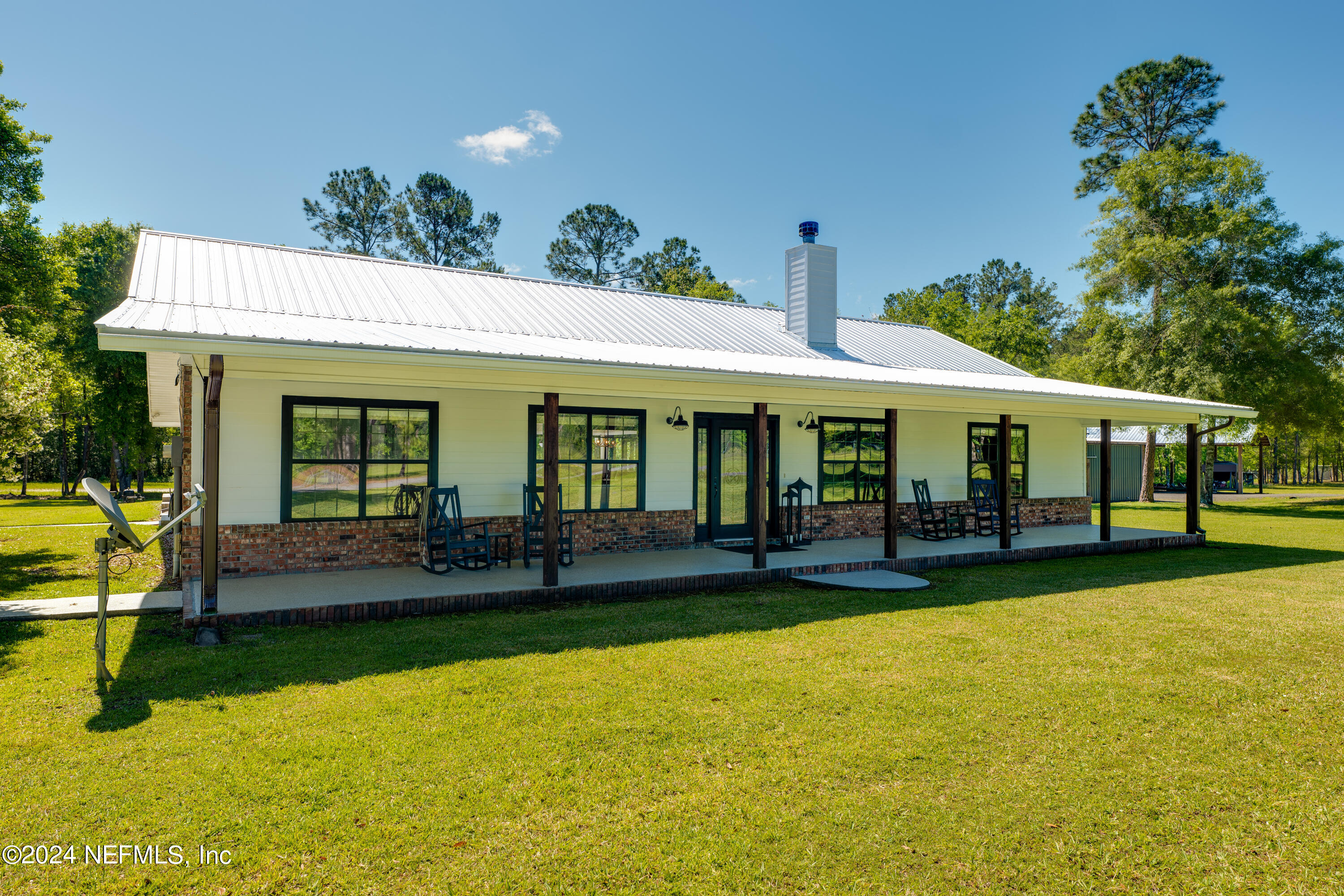 5800 Retreat Road Keystone Heights, FL 32656 - Photo 10 of 121 a front view of a house with swimming pool having outdoor seating