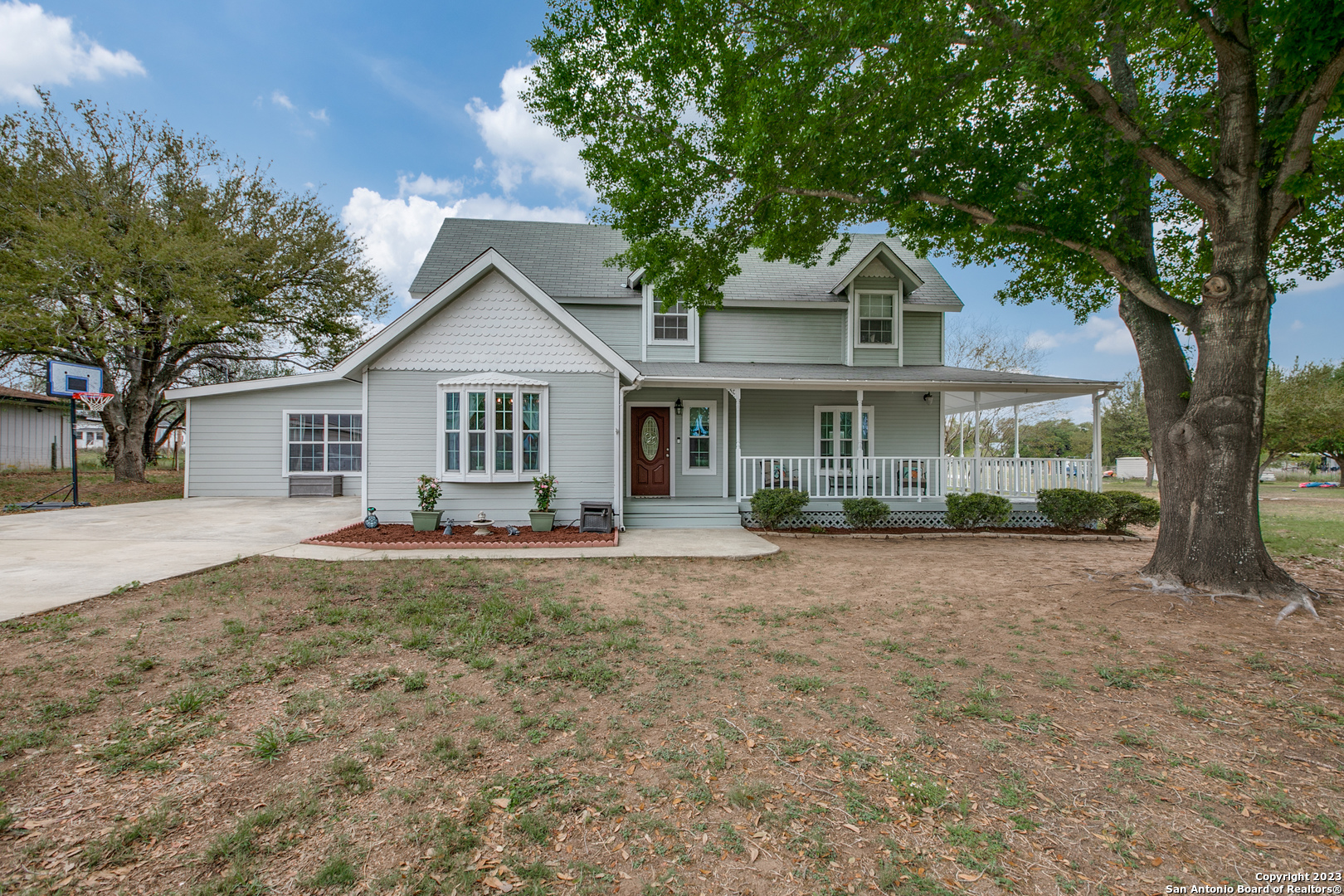 702 County Road 6612 Devine, TX 78016 - Photo 1 of 1 a front view of a house with yard patio and green space