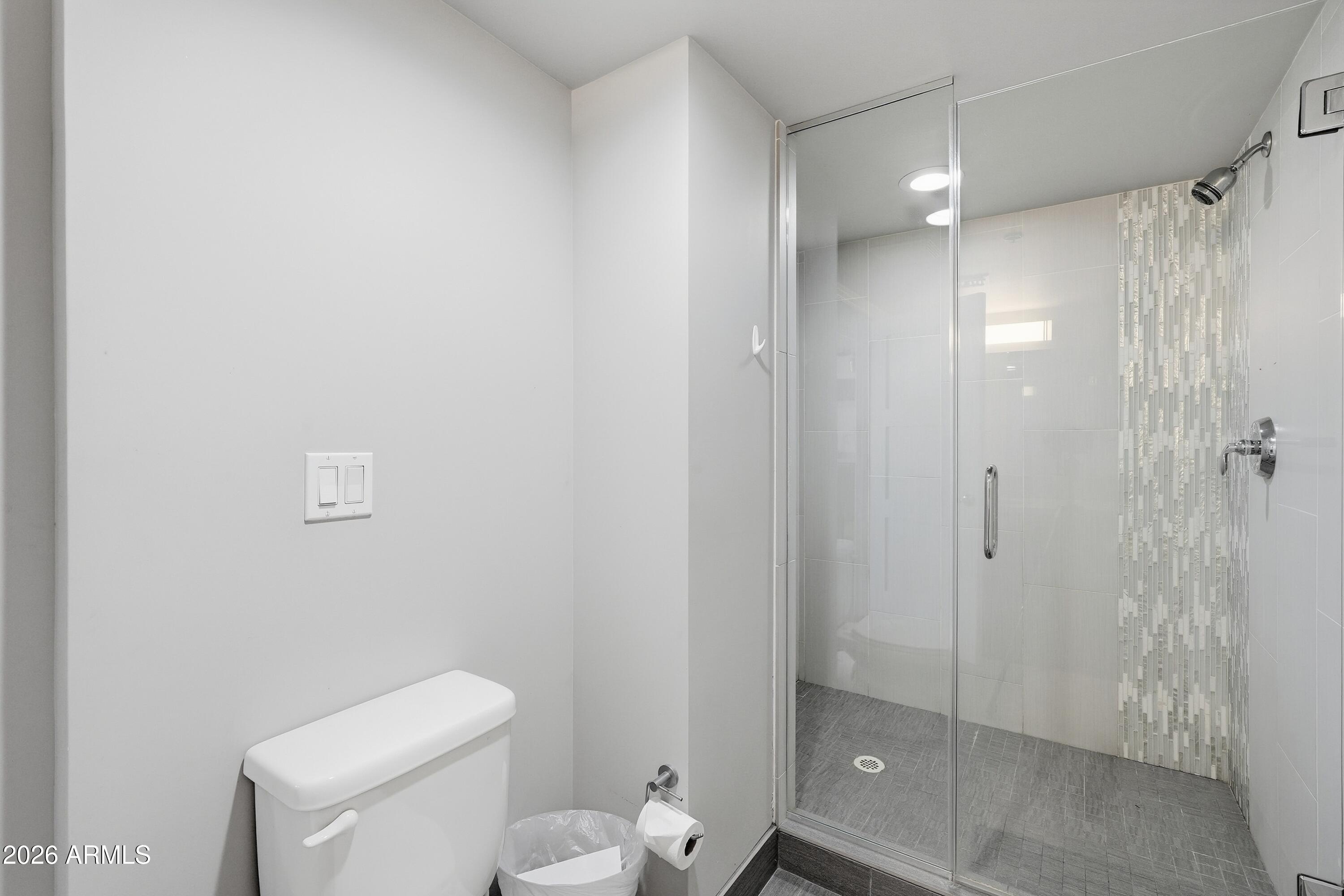 535 West Thomas Road, Unit 210 Phoenix, AZ 85013 - Photo 25 of 40 a bathroom with a shower a toilet and sink