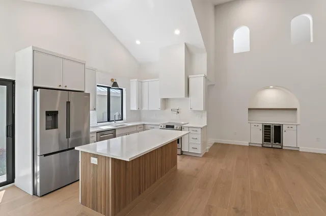 a kitchen with stainless steel appliances a stove a sink and a refrigerator