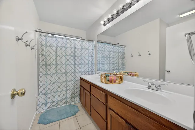 a spacious bedroom with a bed and a large window