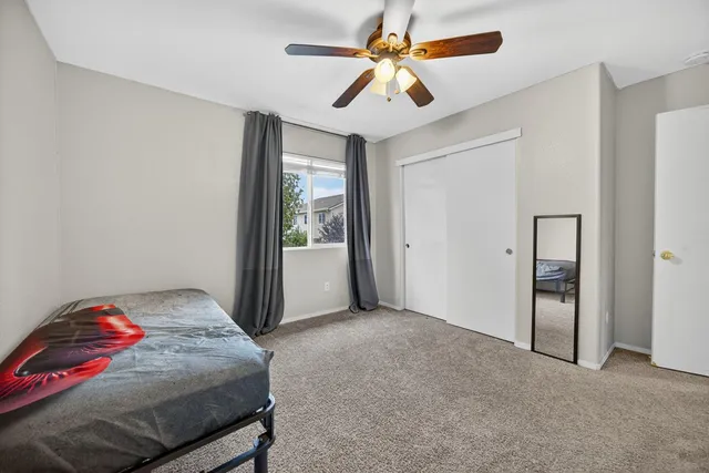 a view of a backyard with table and chairs and wooden fence